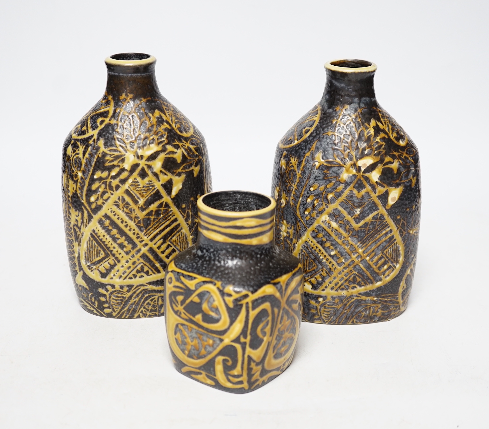 A pair of Royal Copenhagen brown and yellow decorated fajance vases marked 3208 on base and a similar bird decorated squat vase marked 3361 on base, pair of vases 18cm high